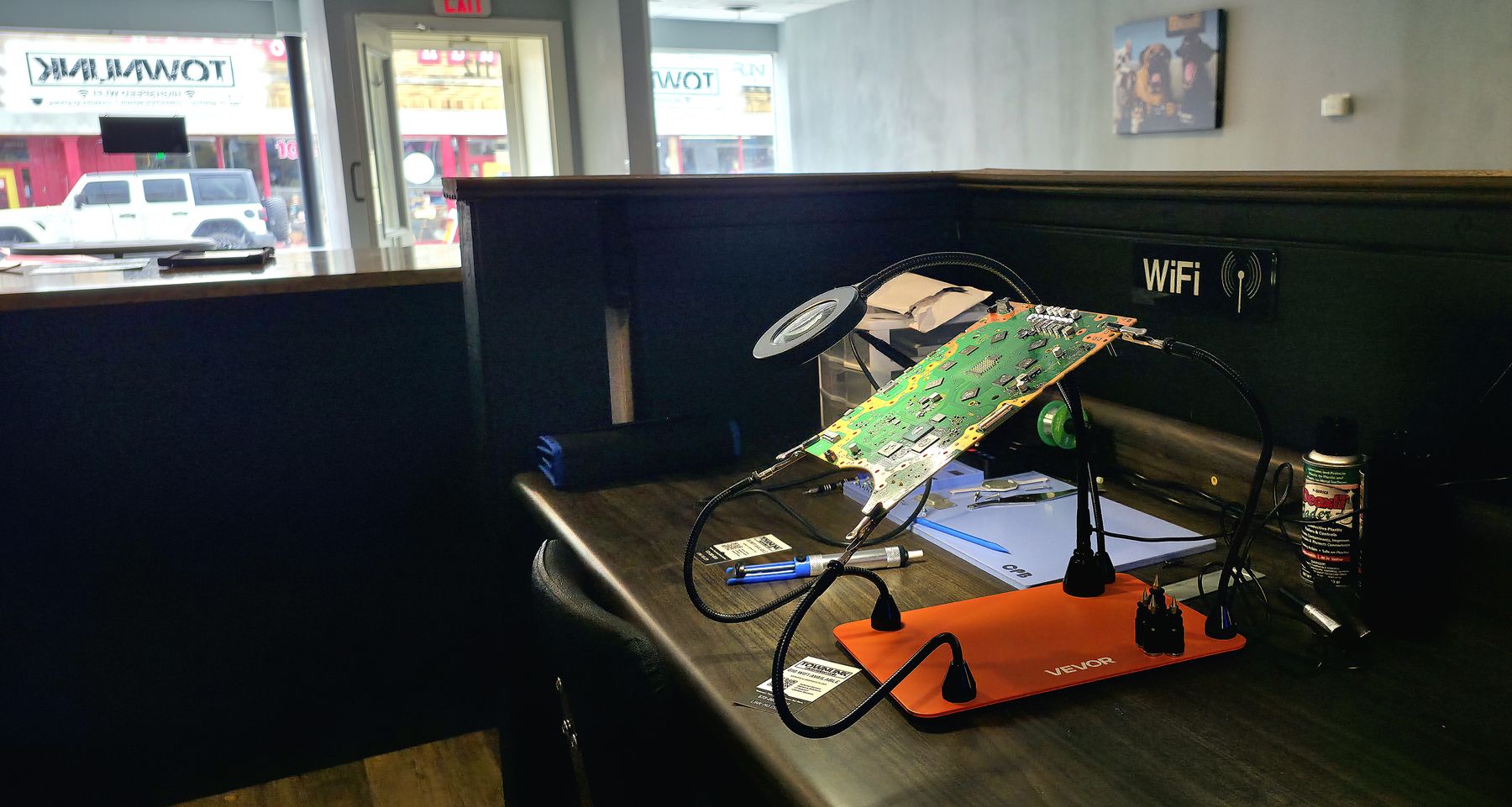 TownLink electronics repair bench with a circuit board under work lights